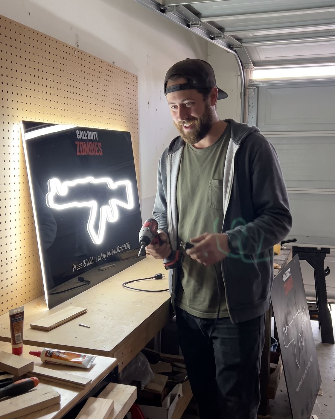 A finished sign lit on the workbench